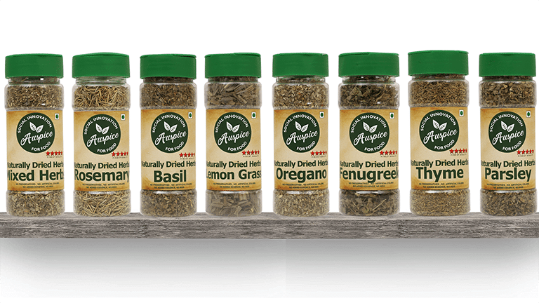 Eight bottles of dried herbs lined up on a shelf, each bearing a label with the Auspice brand logo.